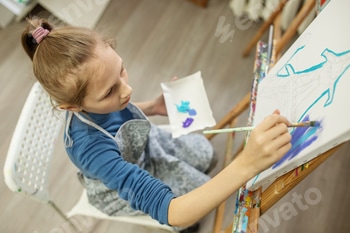 Concentrated Child Painting on Easel. Top view. 2 E101ISOG.jpg?w=350&h=350&cf fit=scale down&mark=https%3A%2F%2Fassets.market storefront.envato static.com%2Fwatermarks%2Fphoto 260724