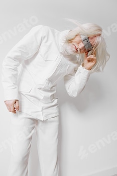 Fashion model with long white hair in a futuristic outfit posing against a minimalistic white 2 E117KMXU.jpg?w=350&h=350&cf fit=scale down&mark=https%3A%2F%2Fassets.market storefront.envato static.com%2Fwatermarks%2Fphoto 260724