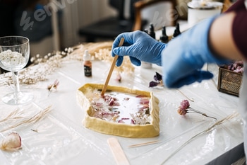 Crafting with resin and dried flowers, using a wooden stick to create detailed art pieces 2 E117XSPX.jpg?w=350&h=350&cf fit=scale down&mark=https%3A%2F%2Fassets.market storefront.envato static.com%2Fwatermarks%2Fphoto 260724