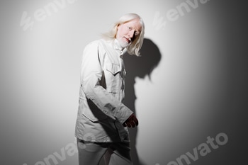 Portrait of an elderly man with long white hair wearing a light outfit, set against a gray 2 E117R77S.jpg?w=350&h=350&cf fit=scale down&mark=https%3A%2F%2Fassets.market storefront.envato static.com%2Fwatermarks%2Fphoto 260724