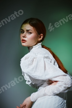 Young woman in elegant vintage dress, showcasing emotion with soft lighting and a blurred green 2 E117KE0S.jpg?w=350&h=350&cf fit=scale down&mark=https%3A%2F%2Fassets.market storefront.envato static.com%2Fwatermarks%2Fphoto 260724