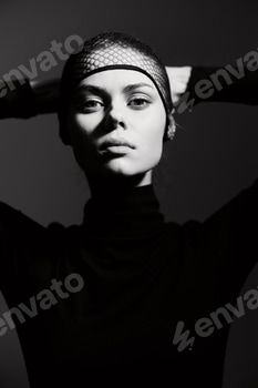 Confident woman posing with hands on head, wearing a stylish black outfit and fishnet headwear 2 E117MACU.jpg?w=350&h=350&cf fit=scale down&mark=https%3A%2F%2Fassets.market storefront.envato static.com%2Fwatermarks%2Fphoto 260724