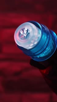 Sex toys for men. Male automatic telescopic masturbator in the hands of a girl in black latex gloves Sex toys for men. Male automatic telescopic masturbator in the hands of a girl in black latex gloves